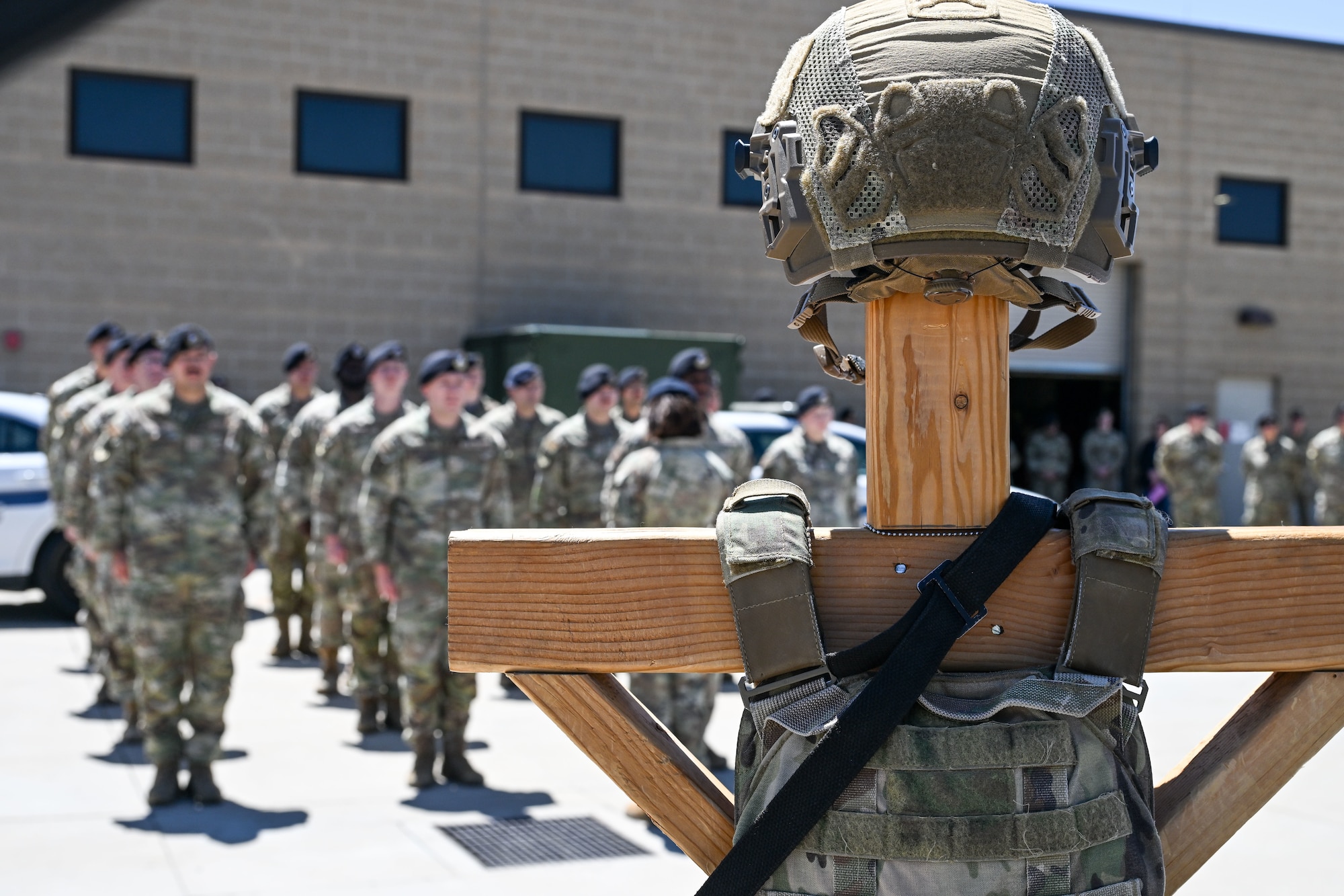 Defenders from the 75th Security Forces Squadron stand at attention as the names of fallen law enforcement members are called out during a ceremonial guard mount