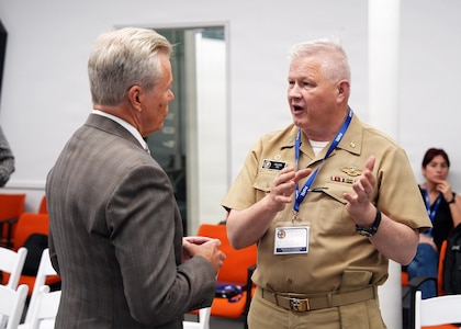SAN ANTONIO – (May 18, 2026) – U.S. Navy Capt. Michael Tiller, commanding officer, Naval Medical Research Unit (NAMRU) San Antonio, speaks with John Lamberton of the DLH Corporation at the Defense Health Agency’s annual Promote Professional Engagement amongst Military Laboratories (ProPEL) Science Symposium held at the VelocityTX Innovation Center. The event brought together military medical professionals, researchers, students, and academic partners to explore the latest in defense health innovation.  Attendees at ProPEL heard from several San Antonio Centers of Excellence to include research presentations on Battlefield/Point of Injury, Prolonged Field Care/Early Interventions, and Integrated Rehabilitation and Human Performance. Collaborating and working alongside a wide range of research and development partners keeps Navy Medicine Research & Development (NMR&D) abreast of best practices and advances in medical knowledge. NAMRU San Antonio, part of NMR&D conducts gap-driven combat casualty care, craniofacial, and directed energy research in support of Navy, Marine Corps and joint U.S. warfighter health readiness and lethality while engaged in routine and expeditionary operations. (Photo by Burrell Parmer, NAMRU San Antonio Public Affairs/Released)