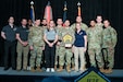 Members of 11th Airborne Division, Fairbanks, Alaska, accept the "Best in Class for the Physical Domain" award for their innovative Wolf Recovery Program at the 2026 Holistic Health and Fitness Symposium (H2F) at the Hampton Roads Convention Center Hampton, VA on May 13-14, 2026.