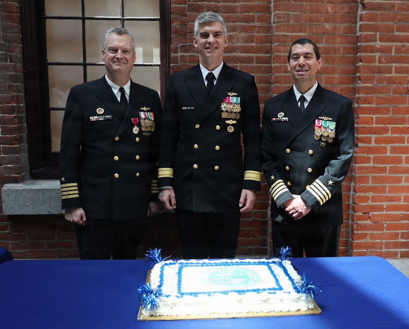 NSWCPD welcomed Capt. Ashley S Wright (right), who relieved Capt. Joseph Darcy (left) as Commanding Officer during NSWCPD’s Change of Command Ceremony in Philadelphia on May 15, 2026. Commander, Naval Surface and Undersea Warfare Centers Rear Adm. Peter Small (center) served as the ceremony’s guest speaker and presided over the change of command. (U.S. Navy photo by Phil Scaringi, CTR)