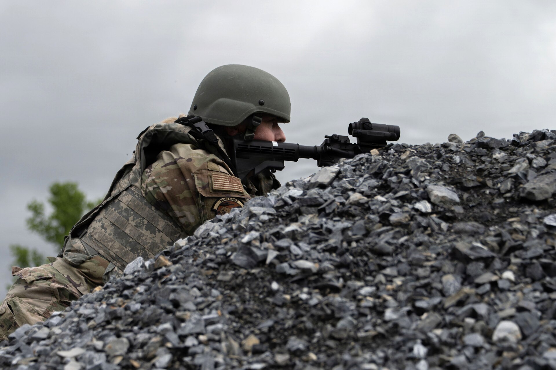 U.S. Air Force Airman 1st Class Kimberly Hartford, 316th Civil Engineer Squadron water and fuels maintenance apprentice, observes the surrounding area from an elevated position during the operational phase of the 316th Wing’s Bivouac exercise at Fort Indiantown Gap, Pennsylvania, April 30, 2026. The exercise evaluated Airmen’s ability to conduct perimeter awareness and assess terrain in an austere expeditionary environment. (U.S. Air Force photo by Staff Sgt. Aubree Owens)