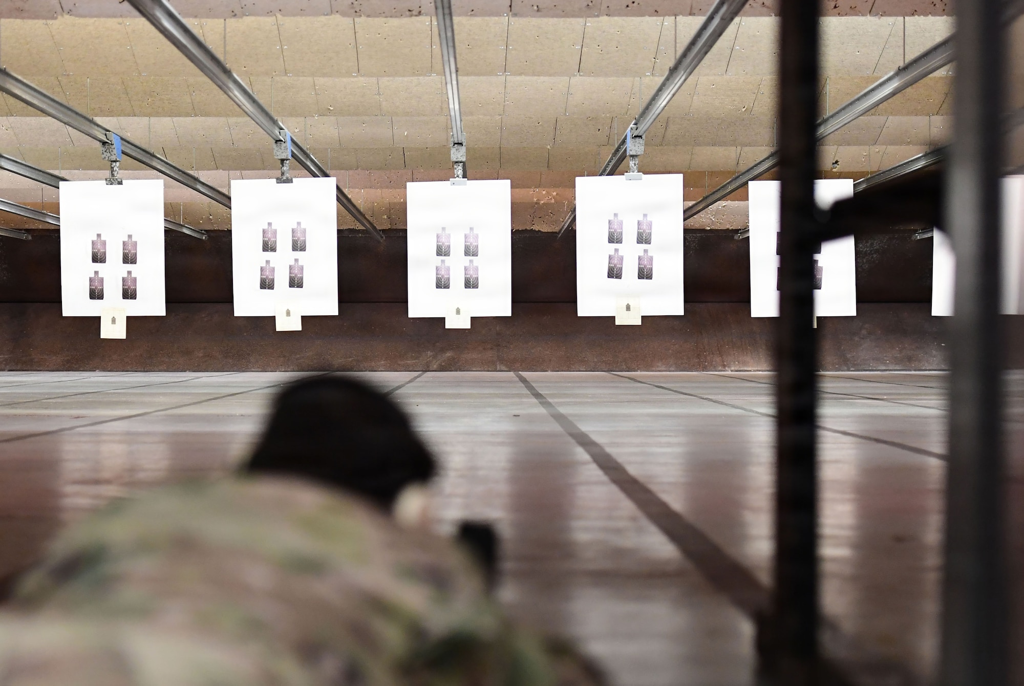 A U.S. Airman fires at targets.
