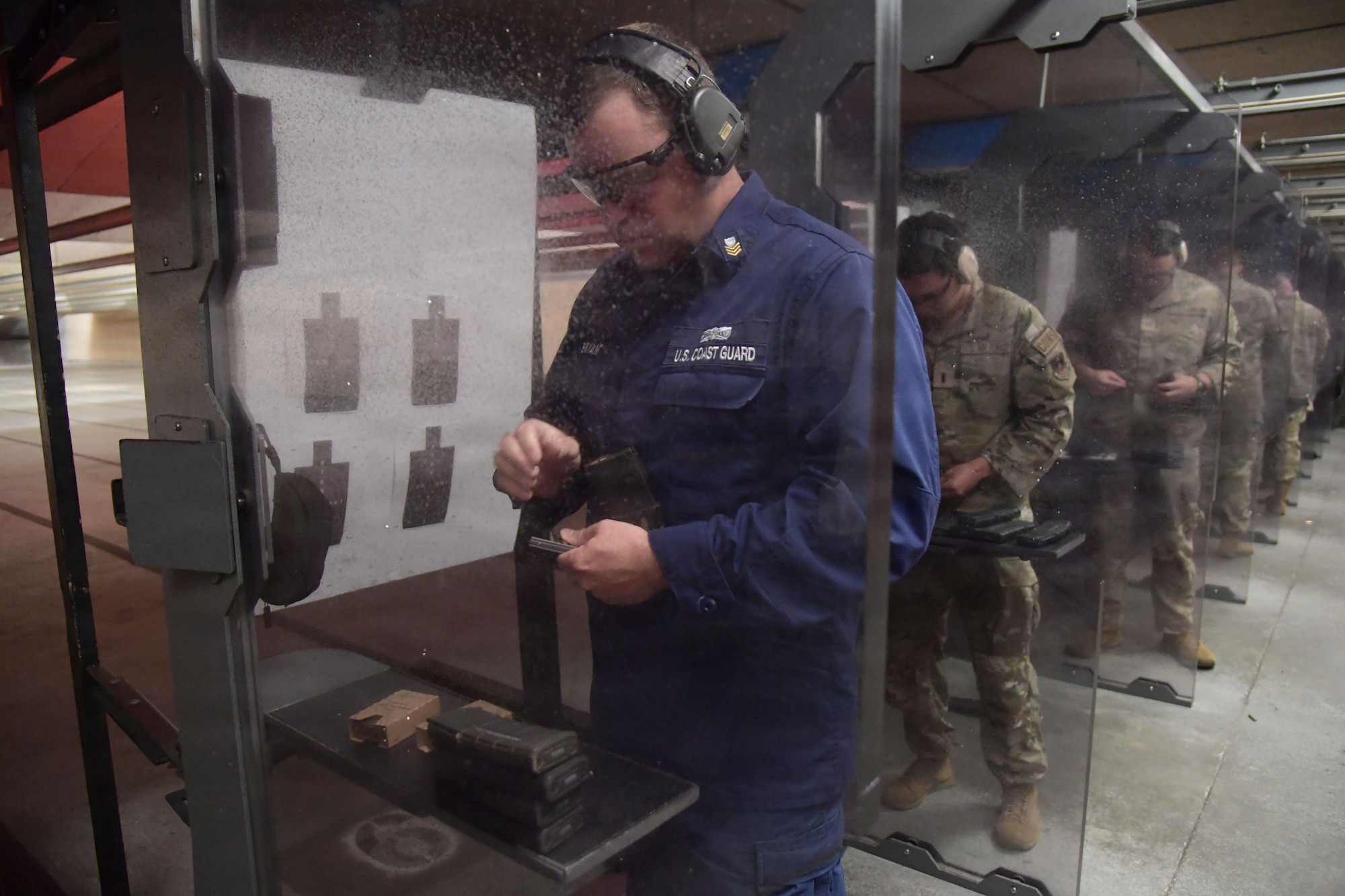 Keesler personnel reload their ammo.