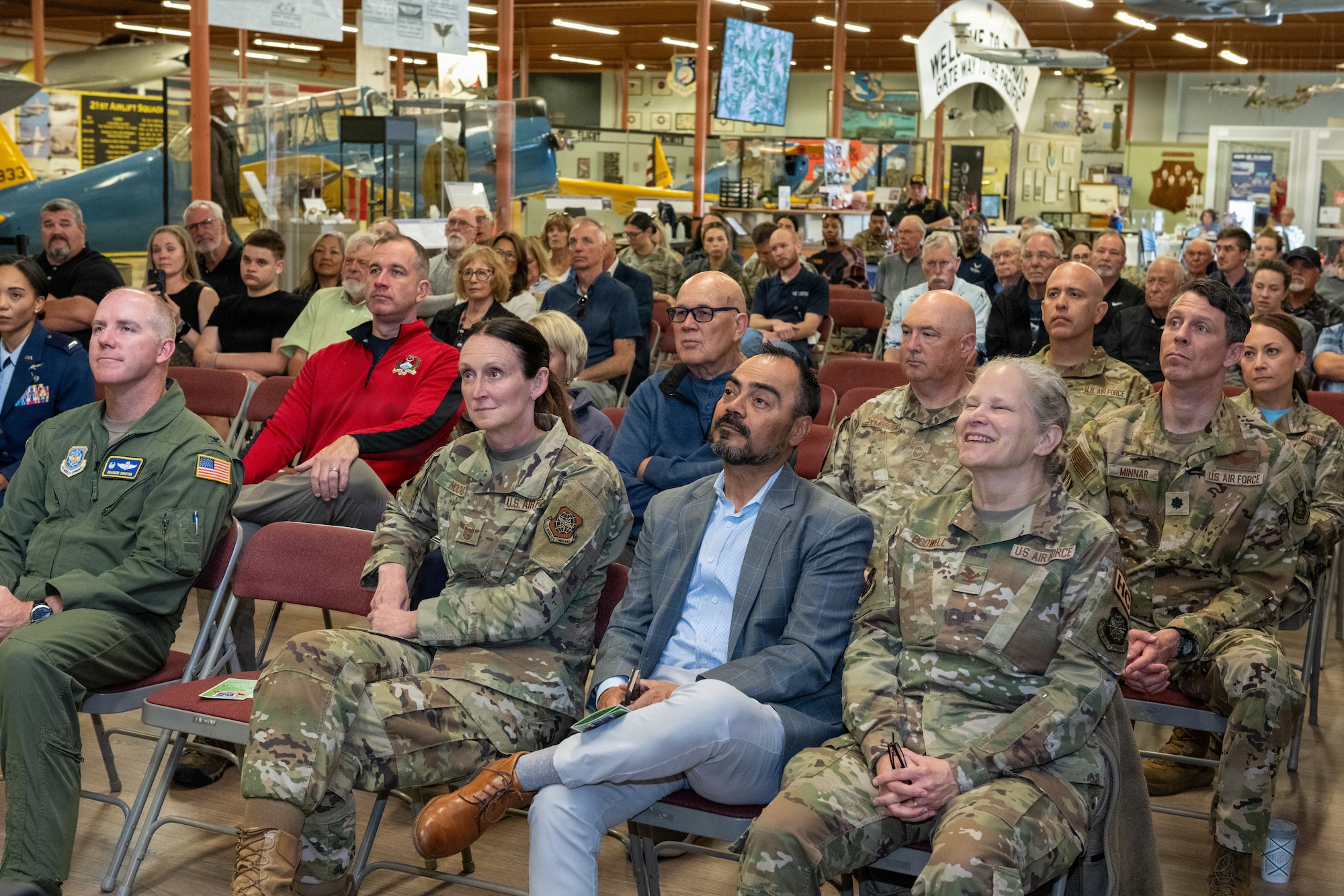 Crowd sitting in chairs listening to remarks