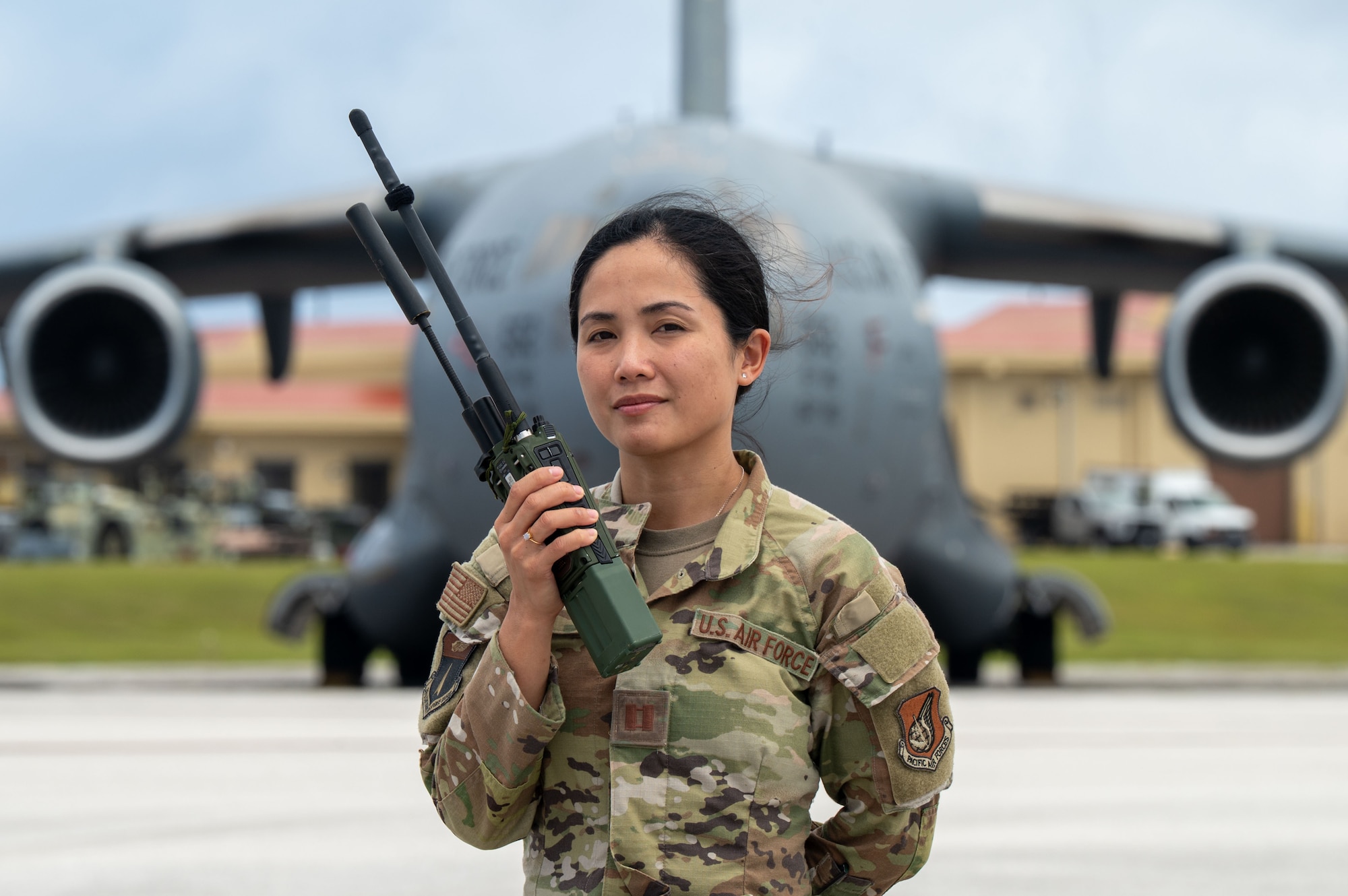 U.S. Air Force Capt. Lyza Taino, a landing zone safety officer with the 36th Contingency Response Squadron, stands in front of a C-17 Globe Master III