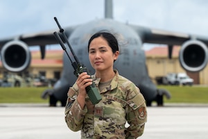 U.S. Air Force Capt. Lyza Taino, a landing zone safety officer with the 36th Contingency Response Squadron, stands in front of a C-17 Globe Master III