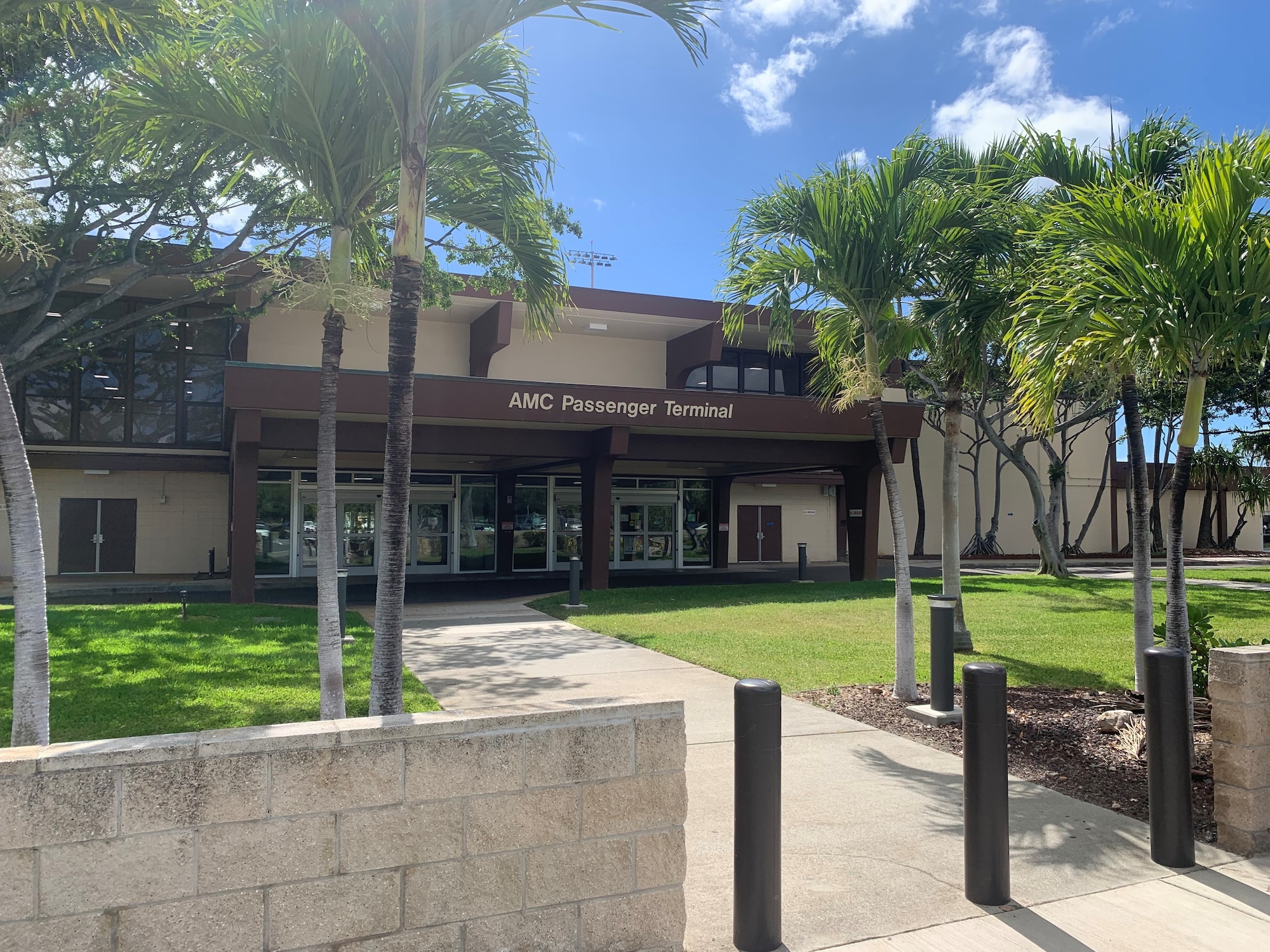 A photo of the front entrance of Hickam AMC Passenger Terminal, at Joint Base Pearl Harbor-Hickam, Hawaii. This building is used to hold and process passengers for military flights.
