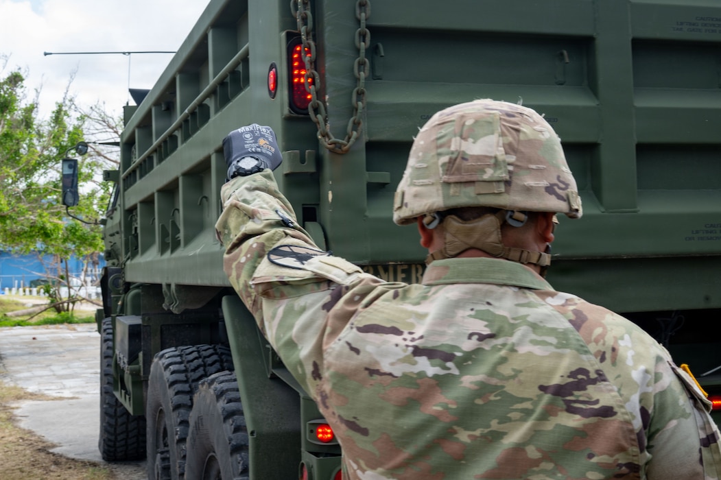 U.S. Army Reservist, Sgt. Vicente Baleto assigned to the 797th Engineer Vertical Construction Company, 9th Mission Support Command, Honolulu, Hawaii, guides a vehicle delivering safe drinking water to Saipan residents as part of Typhoon Sinlaku recovery efforts in Saipan, Commonwealth of the Northern Mariana Islands, May 17, 2026.