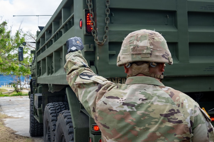 U.S. Army Reservist, Sgt. Vicente Baleto assigned to the 797th Engineer Vertical Construction Company, 9th Mission Support Command, Honolulu, Hawaii, guides a vehicle delivering safe drinking water to Saipan residents as part of Typhoon Sinlaku recovery efforts in Saipan, Commonwealth of the Northern Mariana Islands, May 17, 2026.