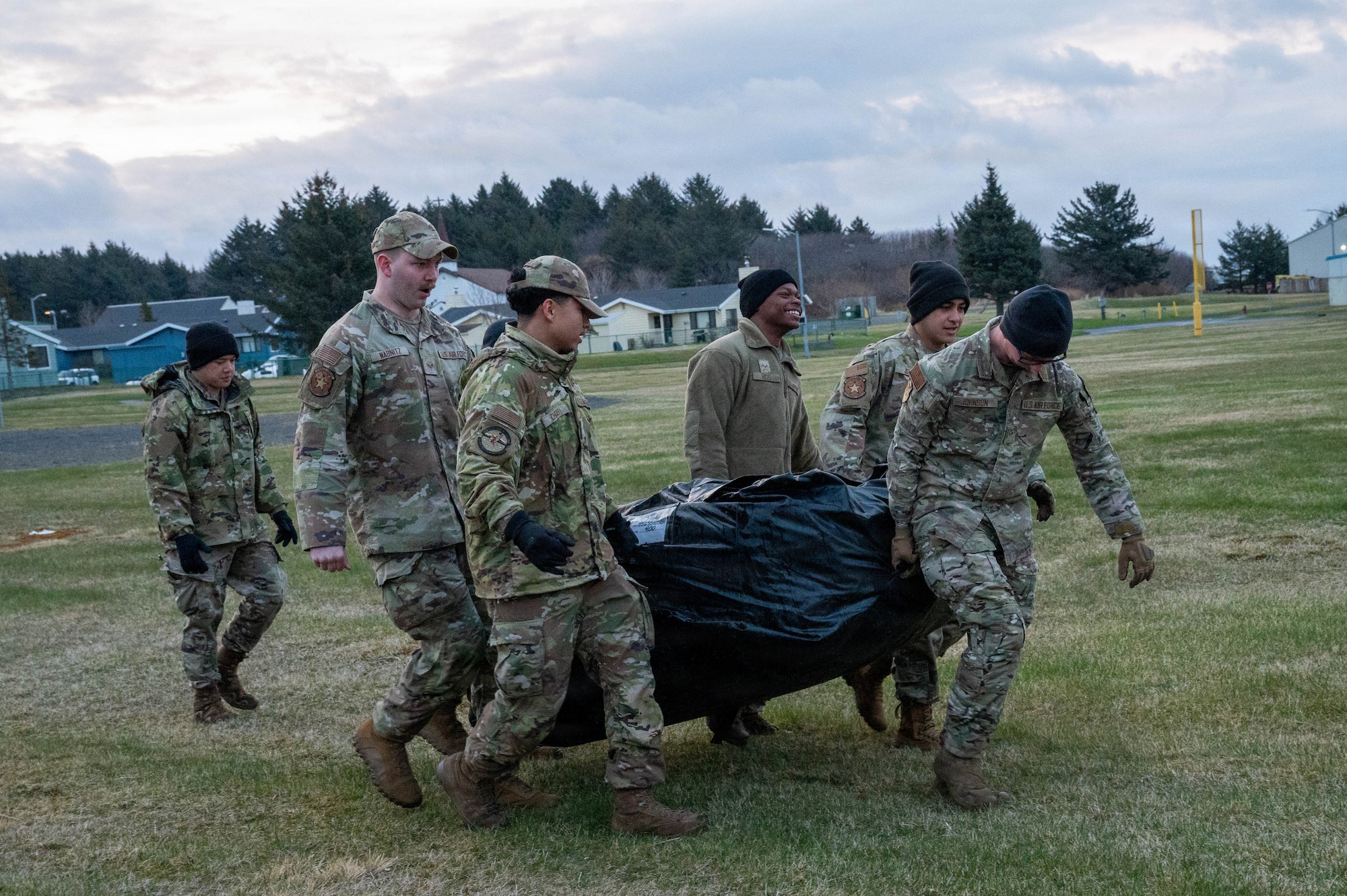 U.S. Airmen deployed with the 3rd Air Expeditionary Wing carry a tent to be set up during Exercise Tropic Tundra 26 at Coast Guard Air Station Kodiak, Alaska, May 11, 2026.