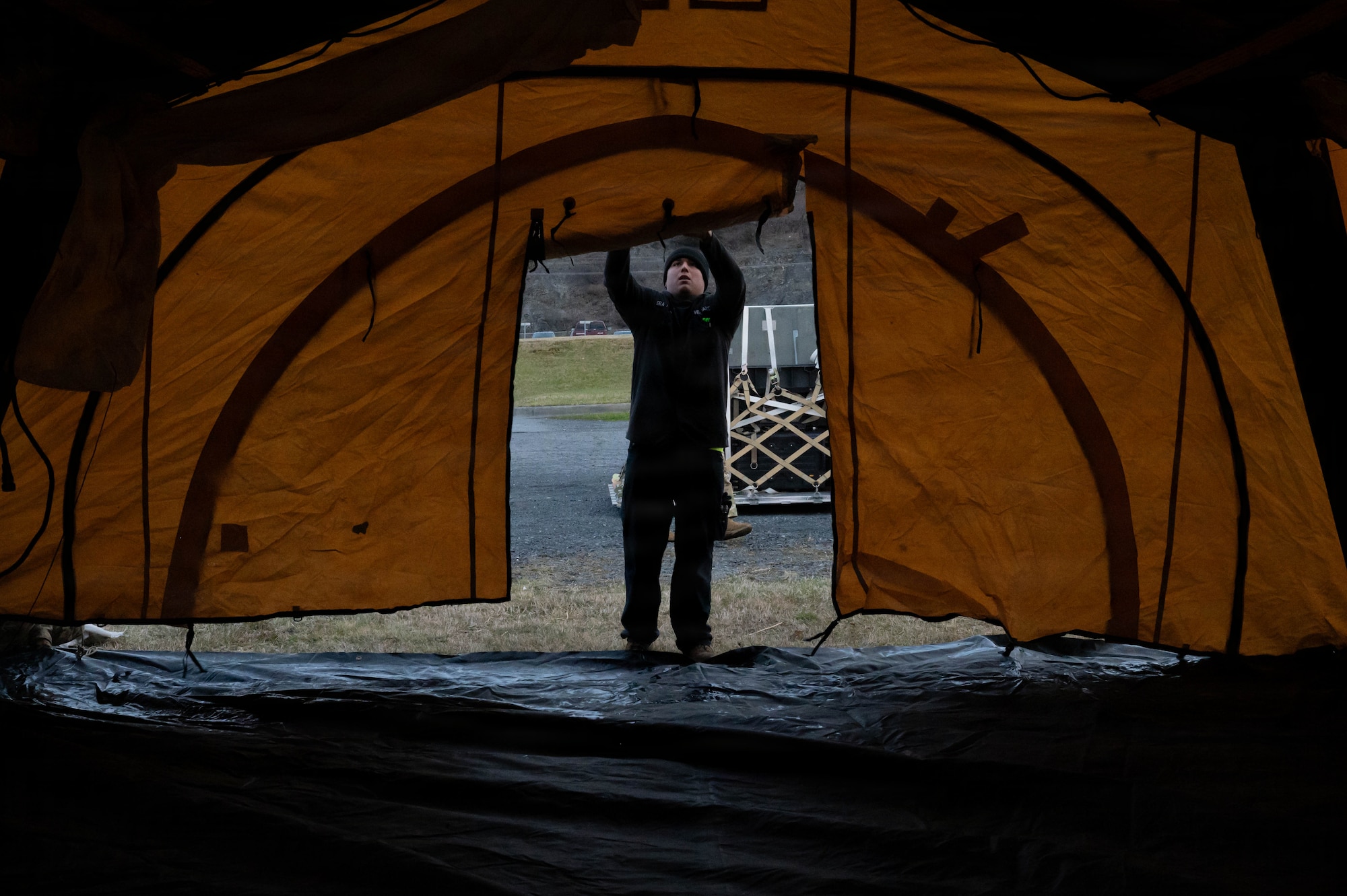 U.S. Air Force Senior Airman Christopher Medina, 673d Logistics Readiness Squadron vehicle maintenance journeyman, helps set up a tent during Exercise Tropic Tundra 26 at Coast Guard Air Station Kodiak, Alaska, May 11, 2026.