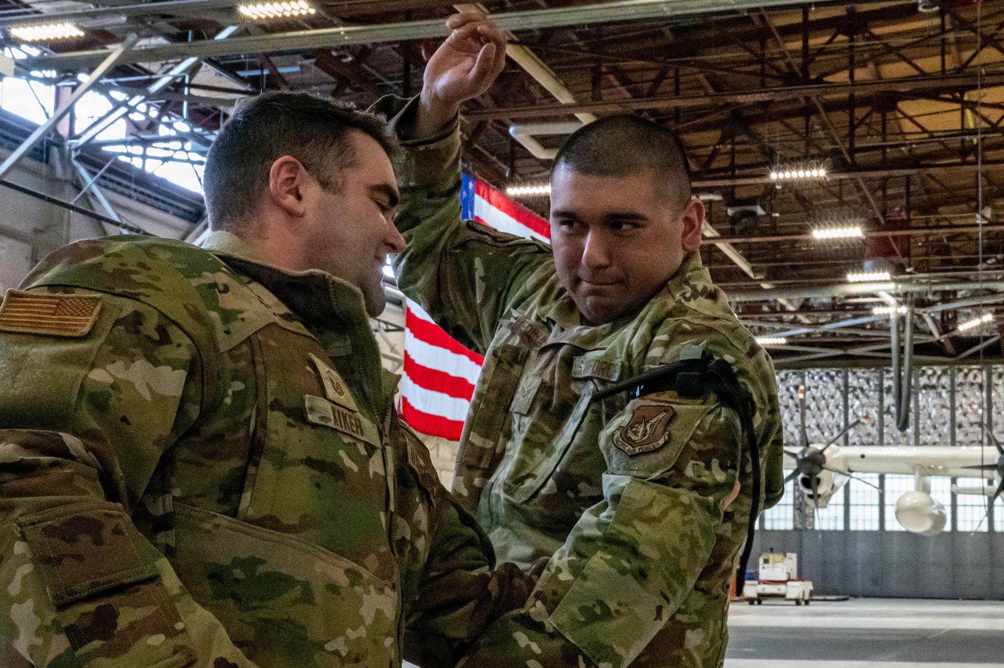 U.S. Air Force Master Sgt. Justin Kiker, 773d Civil Engineer Squadron Heating, Ventilation, and Air Conditioning noncommissioned officer, checks the effectiveness of a tourniquet self-applied by Senior Airman Christopher Medina, 673d Logistics Readiness Squadron vehicle maintenance journeyman, during a Tactical Combat Casualty Care training in preparation for exercise Tropic Tundra 26 at Coast Guard Air Station Kodiak, Alaska, May 8, 2026.