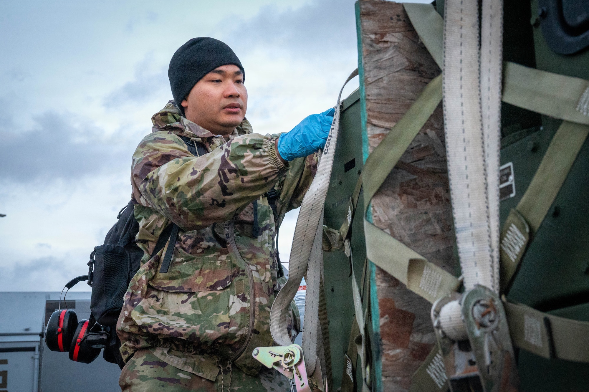 U.S. Air Force Airman 1st Class Nattapat Thawonjak, 773d Civil Engineer Squadron electrical power production journeyman, uncovers a generator during exercise Tropic Tundra 26 at Coast Guard Air Station Kodiak, Alaska, May 11, 2026.