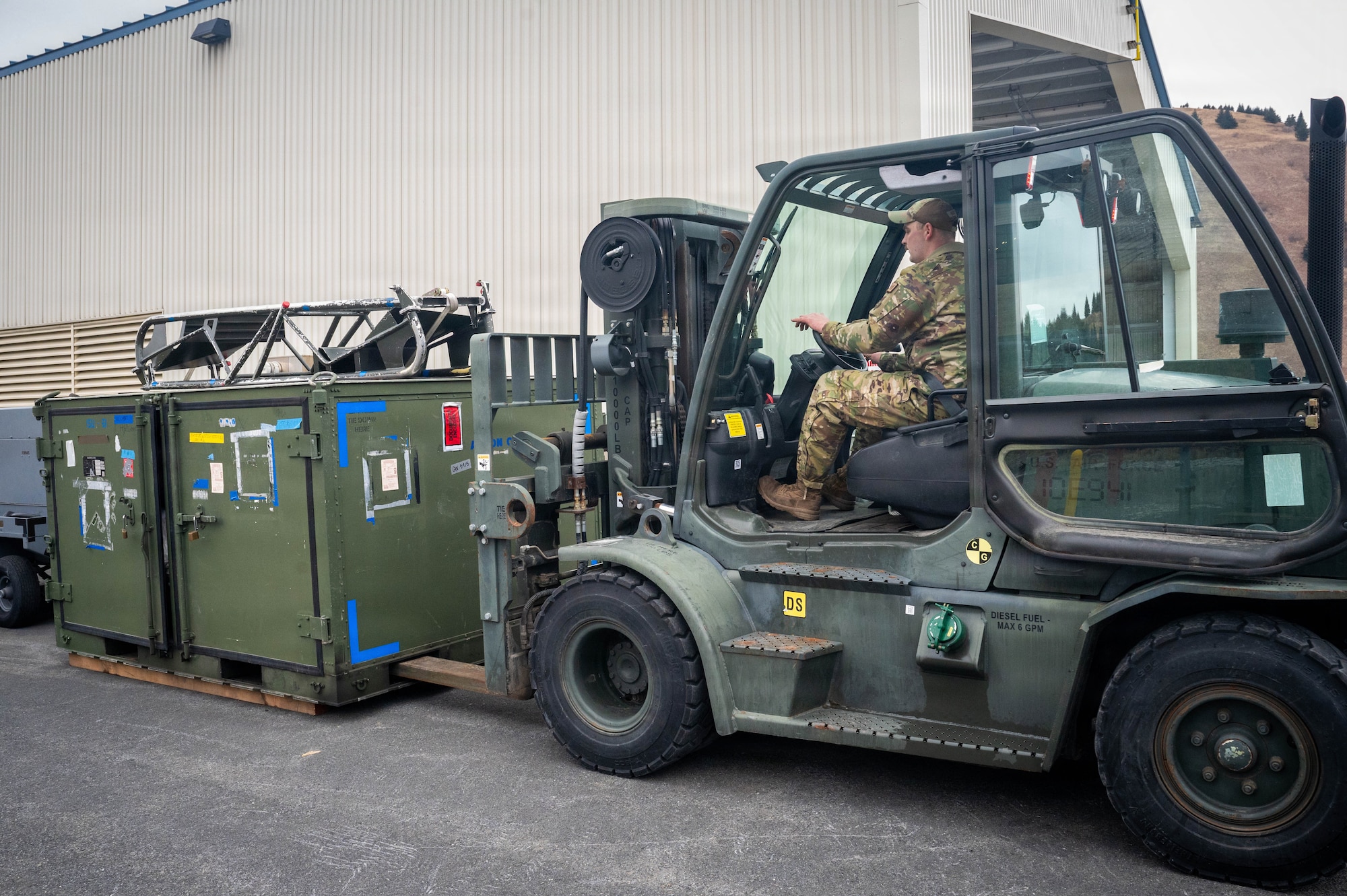 U.S. Air Force Staff Sgt. Christian Navarro, 673d Logistics Readiness Squadron heavy equipment vehicle maintenance supervisor, operates a forklift to deliver flightline equipment during exercise Tropic Tundra 26 at Coast Guard Air Station Kodiak, Alaska, May 11, 2026.
