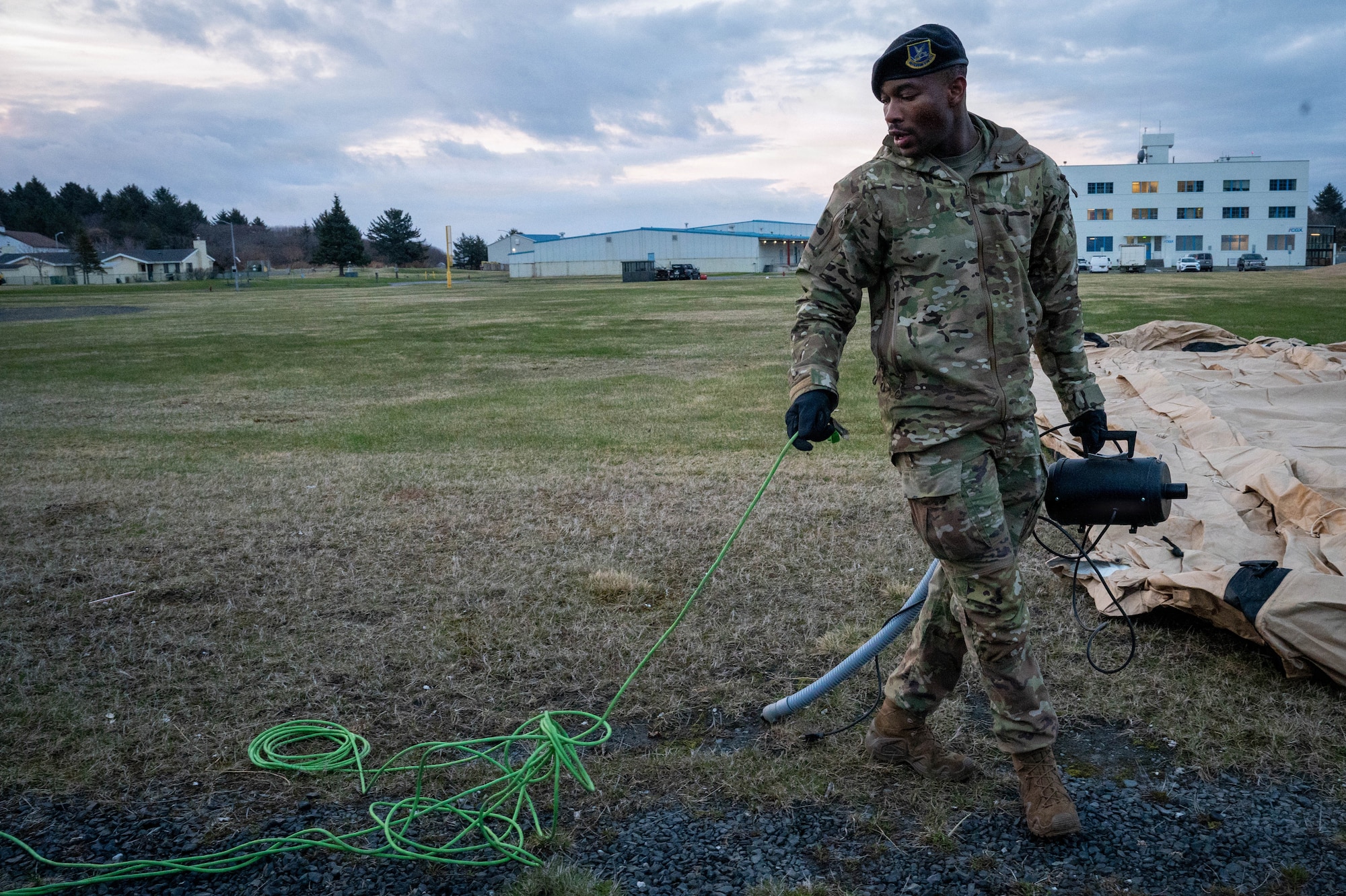 U.S. Air Force Airman 1st Class Tin Teiko, 673d Security Forces defender pulls an extension cord to inflate a tent during Exercise Tropic Tundra 26 at Coast Guard Air Station Kodiak, Alaska, May 11, 2026.