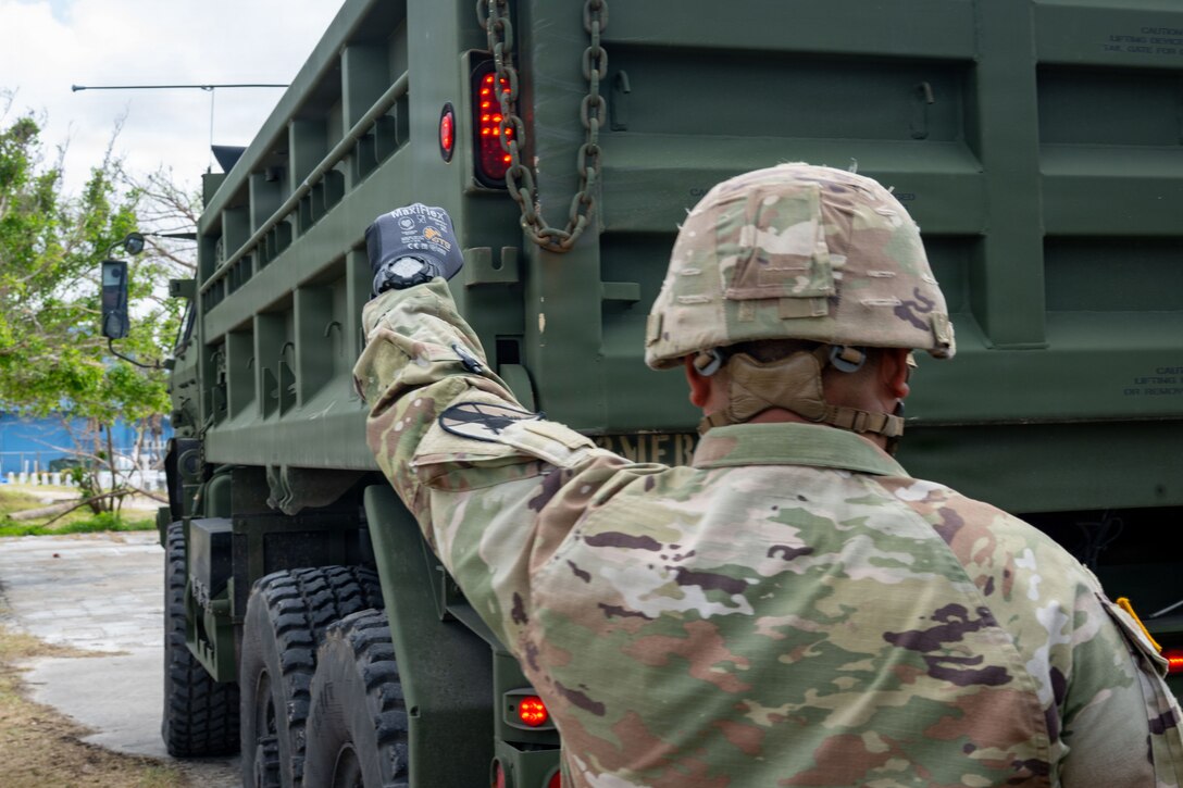 U.S. Army Reservist, Sgt. Vicente Baleto assigned to the 797th Engineer Vertical Construction Company, 9th Mission Support Command, Honolulu, Hawaii, guides a vehicle delivering safe drinking water to Saipan residents as part of Typhoon Sinlaku recovery efforts in Saipan, Commonwealth of the Northern Mariana Islands, May 17, 2026.
