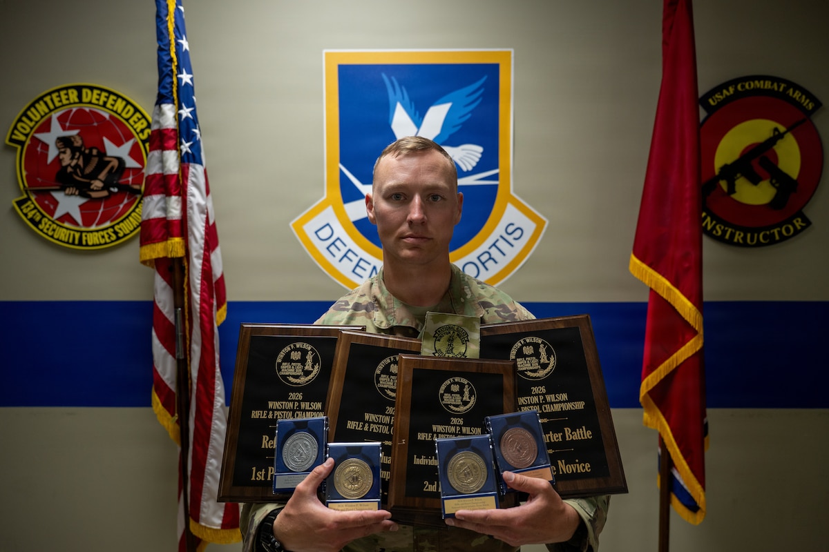 Airman poses with trophies