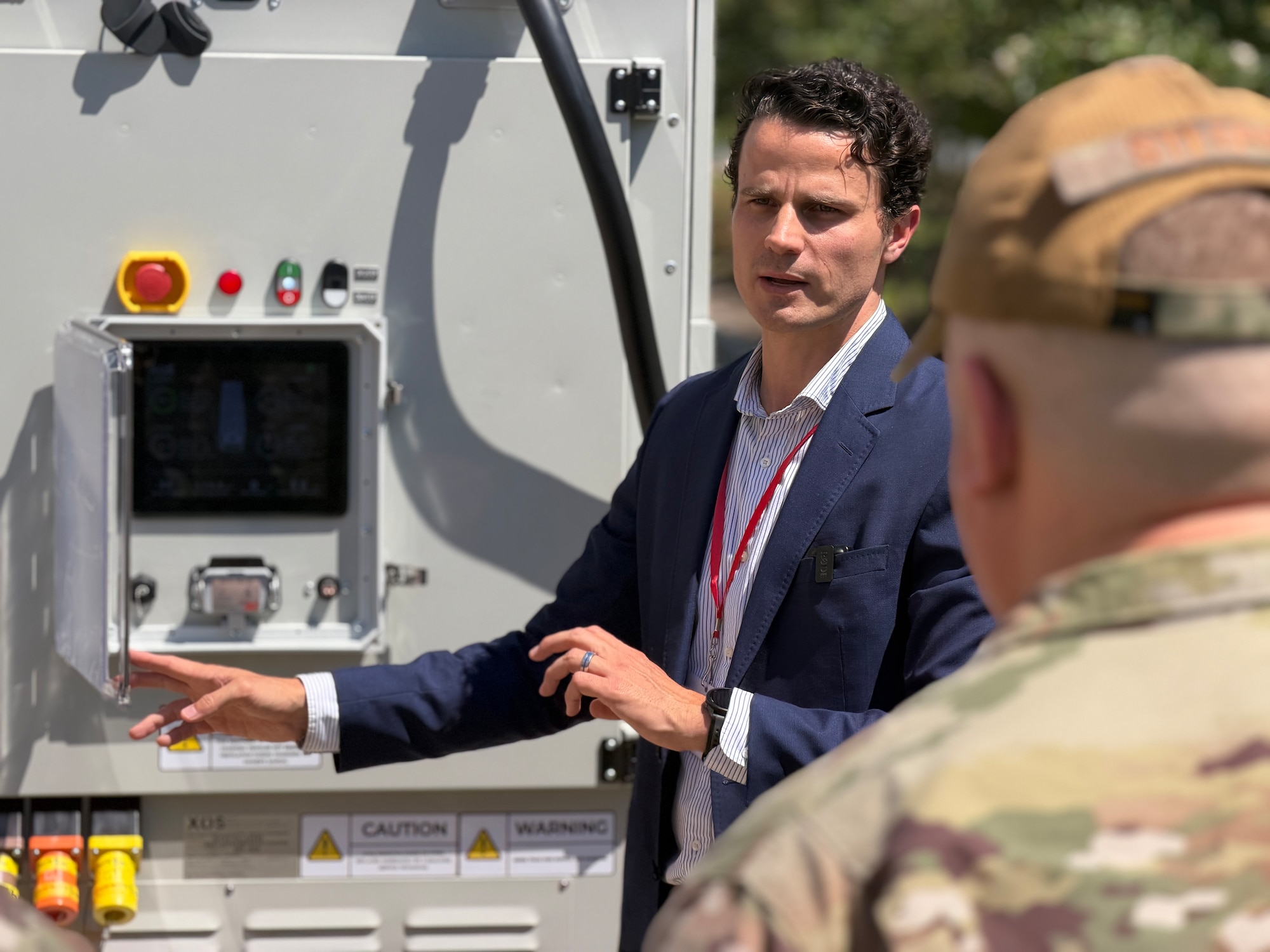 A technology company representative provides a demonstration of a rapidly deployable charging unit to military service members and civilian attendees of the AFGSC Commercial Capabilities Showcase in Bossier City, Louisiana, on May 13, 2026. The two-day showcase brought together military leaders and commercial innovators to accelerate the integration of cutting-edge technology into the nation's long-range strike and deterrence missions, with a focus on several key areas critical to future operations, including quantum sensing, advanced manufacturing, deployable energy solutions, and next-generation defensive systems. (U.S. Air Force courtesy photo of Small Business Consulting Corporation)