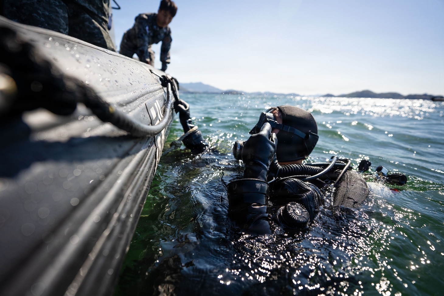 U.S. Navy Diver 3rd Class Mark Obymachow, assigned to Mobile Diving and Salvage Unit 1, stands by to submerge with a Republic of Korea Navy diver to locate a simulated sunken vessel during Salvage Exercise Korea 2026 at Jinhae Naval Base, Republic of Korea, April 7, 2026. Commander, Logistics Group Western Pacific/Task Force 73 sustains the U.S. Navy’s maritime forces and is responsible for all diving and salvage operations in the Western Pacific in support of a free and open Indo-Pacific. (U.S. Navy photo by Mass Communication Specialist 2nd Class Jordan Jennings)
