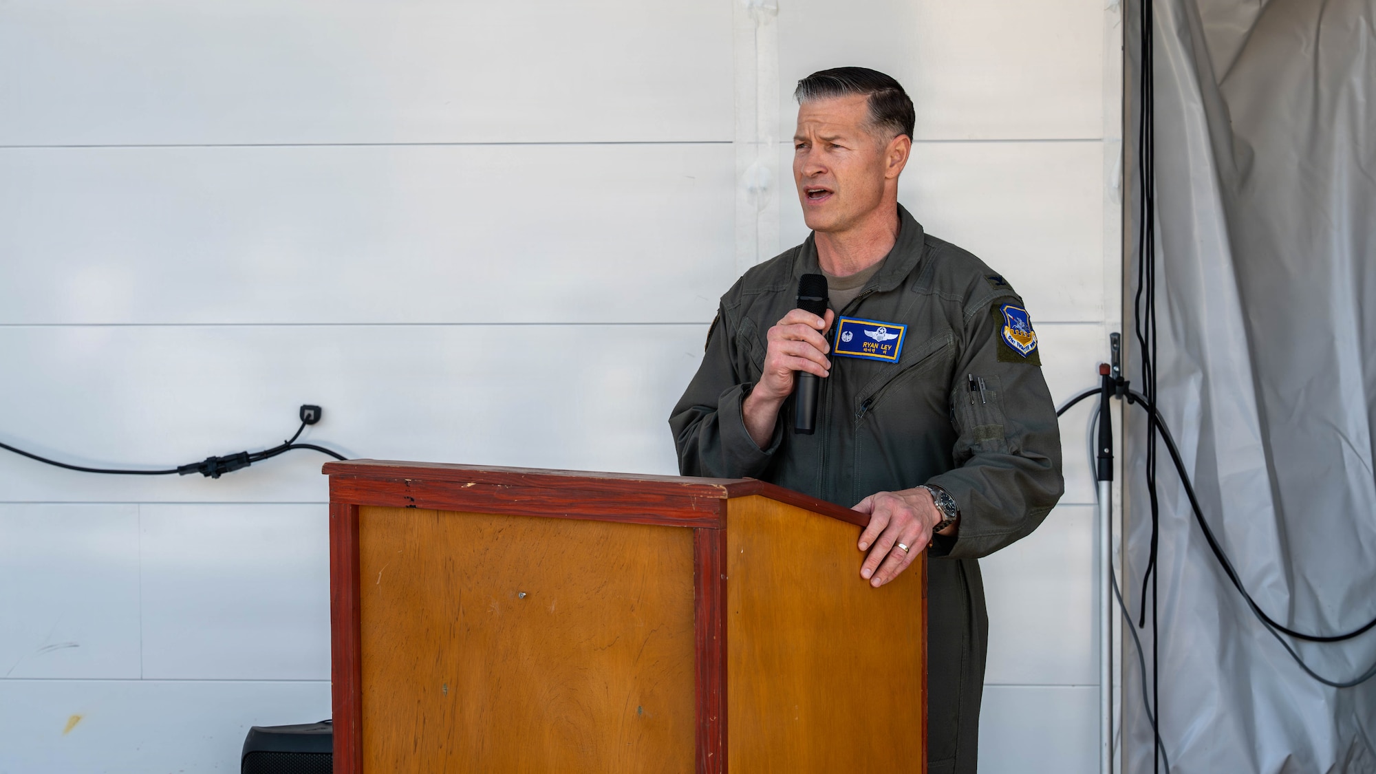 U.S. Air Force Col. Ryan Ley, 51st Fighter Wing commander, provides remarks during a ribbon cutting ceremony for a new deployable corrosion prevention and control facility at Osan Air Base, Republic of Korea, May 18, 2026. The new capability reduces aircraft restoration timelines and increases aircraft availability for the 51st Fighter Wing mission. (U.S. Air Force photo by Airman 1st Class Megan Cusmano)