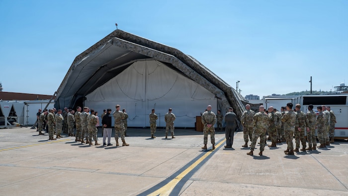 Attendees gather outside a new deployable corrosion prevention and control facility during a ribbon cutting ceremony at Osan Air Base, Republic of Korea, May 18, 2026. The facility restores full on-site aircraft corrosion control operations for the 51st Maintenance Squadron, allowing maintainers to complete critical F-16 Fighting Falcon restoration work at Osan AB. (U.S. Air Force photo by Airman 1st Class Megan Cusmano)