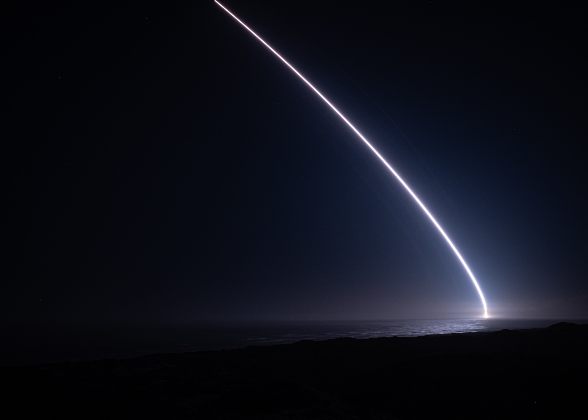 A rocket lights up the night sky.