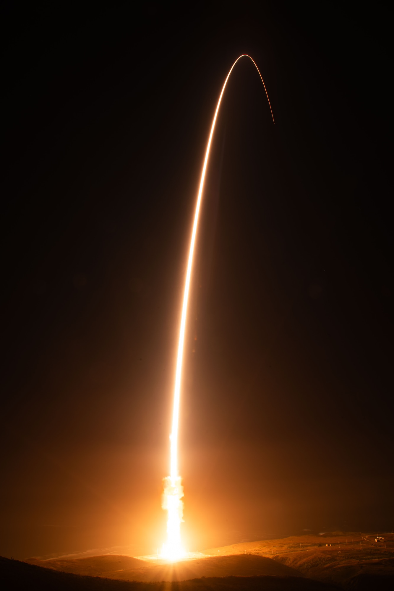 A rocket lights up the night sky.