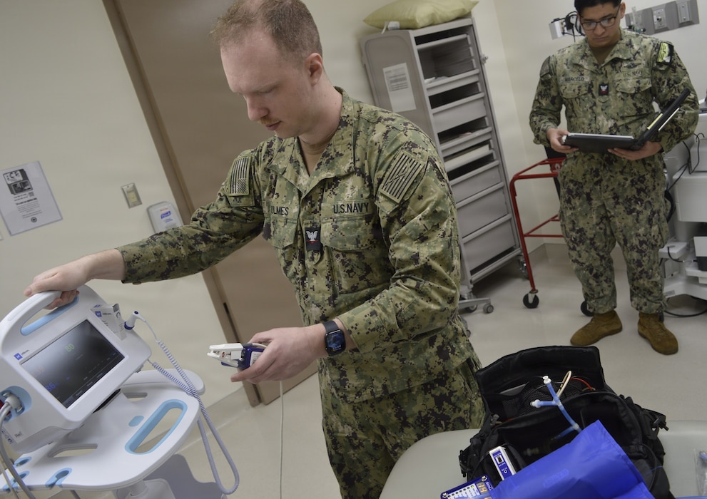 Answering the call of tech need...Hospital Corpsman 3rd Class Jacob Holmes and Hospital Corpsman 2nd Class Renzo Marcelo, biomedical equipment technicians assigned to NMRTC Bremerton, troubleshoot equipment in Naval Hospital Bremerton's ENT [Ears, Nose Throat] Clinic during Healthcare Technology Management Week, May 19-25, 2026, celebrated by Defense Health Agency Medical Logistics in conjunction with the Association for the Advancement of Medical Instrumentation, to promote awareness of the daily contributions of healthcare technology management professionals [official Navy photo by Douglas H Stutz, NHB/NMRTC Bremerton public affairs officer].