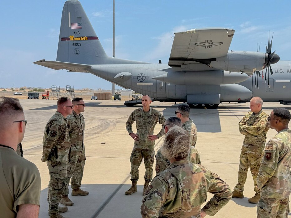 U.S. Air Force Col. Gabriel Brown, 406th Air Expeditionary Wing commander, center, engages with members from the 449th Air Expeditionary Group during a commander immersion tour at Camp Lemonnier, Djibouti, April 11, 2026. The 449th AEG provides personnel recovery task forces, intra-theater airlift, base operating support integrator, intelligence, surveillance, and reconnaissance capabilities, and aircraft launch and recovery elements in support USAFRICOM. (U.S. Air Force photo by Tech. Sgt. Jariel Quintana-Contreras)