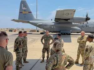 U.S. Air Force Col. Gabriel Brown, 406th Air Expeditionary Wing commander, center, engages with members from the 449th Air Expeditionary Group during a commander immersion tour at Camp Lemonnier, Djibouti, April 11, 2026. The 449th AEG provides personnel recovery task forces, intra-theater airlift, base operating support integrator, intelligence, surveillance, and reconnaissance capabilities, and aircraft launch and recovery elements in support USAFRICOM. (U.S. Air Force photo by Tech. Sgt. Jariel Quintana-Contreras)