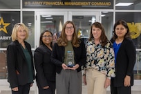 From left to right, Cynthia Price, U.S. Army Financial Management Command Army Accounting and Audit Operations systems accountant; Tamika McMillan, USAFMCOM A3O accountant; Amanda McCoy, USAFMCOM A3O supervisory accountant; Shannon Tabbert, USAFMCOM A3O financial management analyst; and Esther Richard, USAFMCOM A3O accountant, pose for a photo while holding a financial management award from the Under Secretary of Defense (Comptroller) for their contributions to financial integrity and audit results at the Maj. Gen. Emmett J. Bean Federal Center Sept. 5, 2025. The team received the award for their efforts that supported the Army’s downgrade of its material weakness for Fund Balance with Treasury, the first material weakness to be downgraded in the Army’s General Fund. (U.S. Army photo by Mark R. W. Orders-Woempner)
