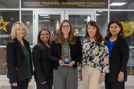 From left to right, Cynthia Price, U.S. Army Financial Management Command Army Accounting and Audit Operations systems accountant; Tamika McMillan, USAFMCOM A3O accountant; Amanda McCoy, USAFMCOM A3O supervisory accountant; Shannon Tabbert, USAFMCOM A3O financial management analyst; and Esther Richard, USAFMCOM A3O accountant, pose for a photo while holding a financial management award from the Under Secretary of Defense (Comptroller) for their contributions to financial integrity and audit results at the Maj. Gen. Emmett J. Bean Federal Center Sept. 5, 2025. The team received the award for their efforts that supported the Army’s downgrade of its material weakness for Fund Balance with Treasury, the first material weakness to be downgraded in the Army’s General Fund. (U.S. Army photo by Mark R. W. Orders-Woempner)