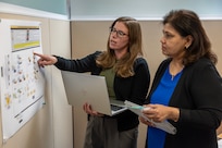 Amanda McCoy, U.S. Army Financial Management Command Army Accounting and Audit Operations supervisory accountant, left, works with Esther Richard, USAFMCOM A3O accountant, at the Maj. Gen. Emmett J. Bean Federal Center Sept. 5, 2025. McCoy and Richard were part of a five-person team who received a financial management award from the Under Secretary of Defense (Comptroller) for their efforts that supported the Army’s downgrade of its material weakness for Fund Balance with Treasury, the first material weakness to be downgraded in the Army’s General Fund. (U.S. Army photo by Mark R. W. Orders-Woempner)