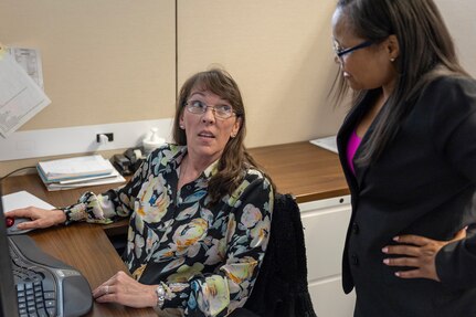 Shannon Tabbert, U.S. Army Financial Management Command Army Accounting and Audit Operations financial management analyst, left, works with Tamika McMillan, USAFMCOM A3O accountant, at the Maj. Gen. Emmett J. Bean Federal Center Sept. 5, 2025. Tabbert and McMillan were part of a five-person team who received a financial management award from the Under Secretary of Defense (Comptroller) for their efforts that supported the Army’s downgrade of its material weakness for Fund Balance with Treasury, the first material weakness to be downgraded in the Army’s General Fund. (U.S. Army photo by Mark R. W. Orders-Woempner)