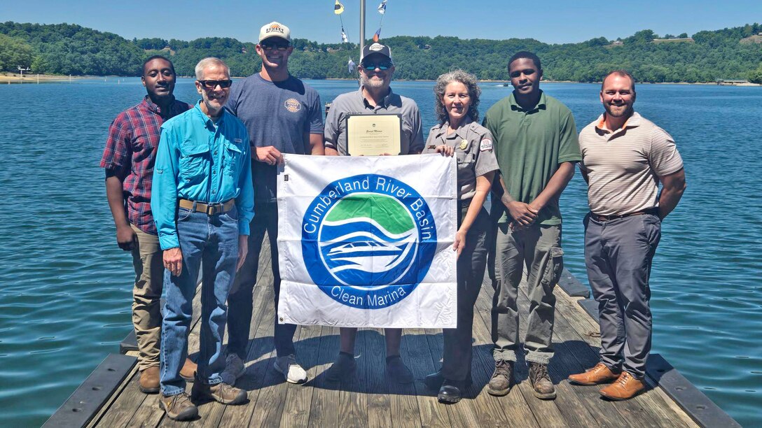 The U.S. Army Corps of Engineers Nashville District officials present the “Clean Marina” flag May 12, 2026, to officials at Sunset Marina and Resort on the shoreline of Dale Hollow Lake in Monroe, Tennessee. The marina accomplished all checklist items and demonstrated a willingness to protect and preserve the water and environment at Dale Hollow Lake.  (USACE Photo by Lori Neubert)