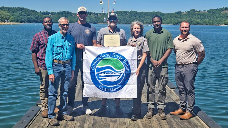 The U.S. Army Corps of Engineers Nashville District officials present the “Clean Marina” flag May 12, 2026, to officials at Sunset Marina and Resort on the shoreline of Dale Hollow Lake in Monroe, Tennessee. The marina accomplished all checklist items and demonstrated a willingness to protect and preserve the water and environment at Dale Hollow Lake.  (USACE Photo by Lori Neubert)
