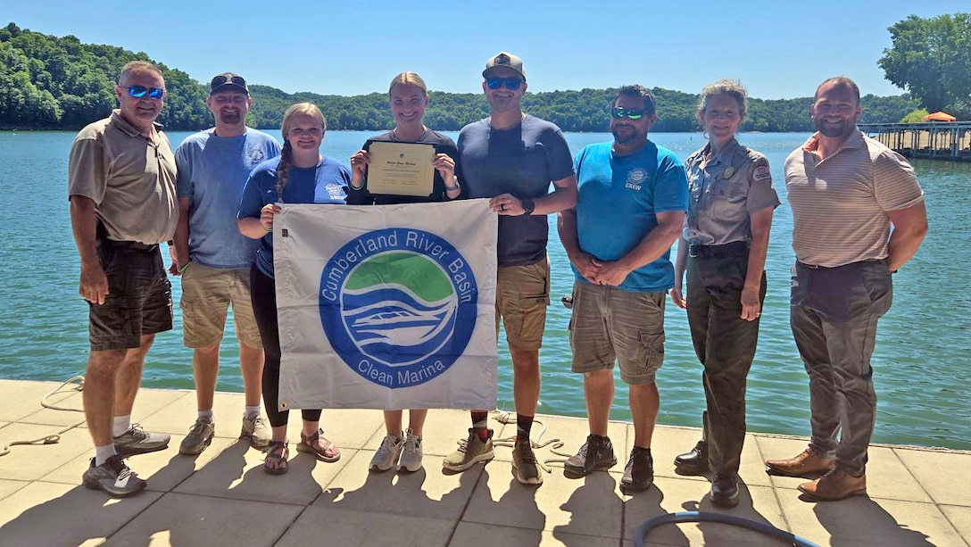 The U.S. Army Corps of Engineers Nashville District officials present the “Clean Marina” flag May 12, 2026, to officials at Willow Grove Resort & Marina on the shoreline of Dale Hollow Lake in Allons, Tennessee. The marina accomplished all checklist items and demonstrated a willingness to protect and preserve the water and environment at Dale Hollow Lake.  (USACE Photo by Lori Neubert)