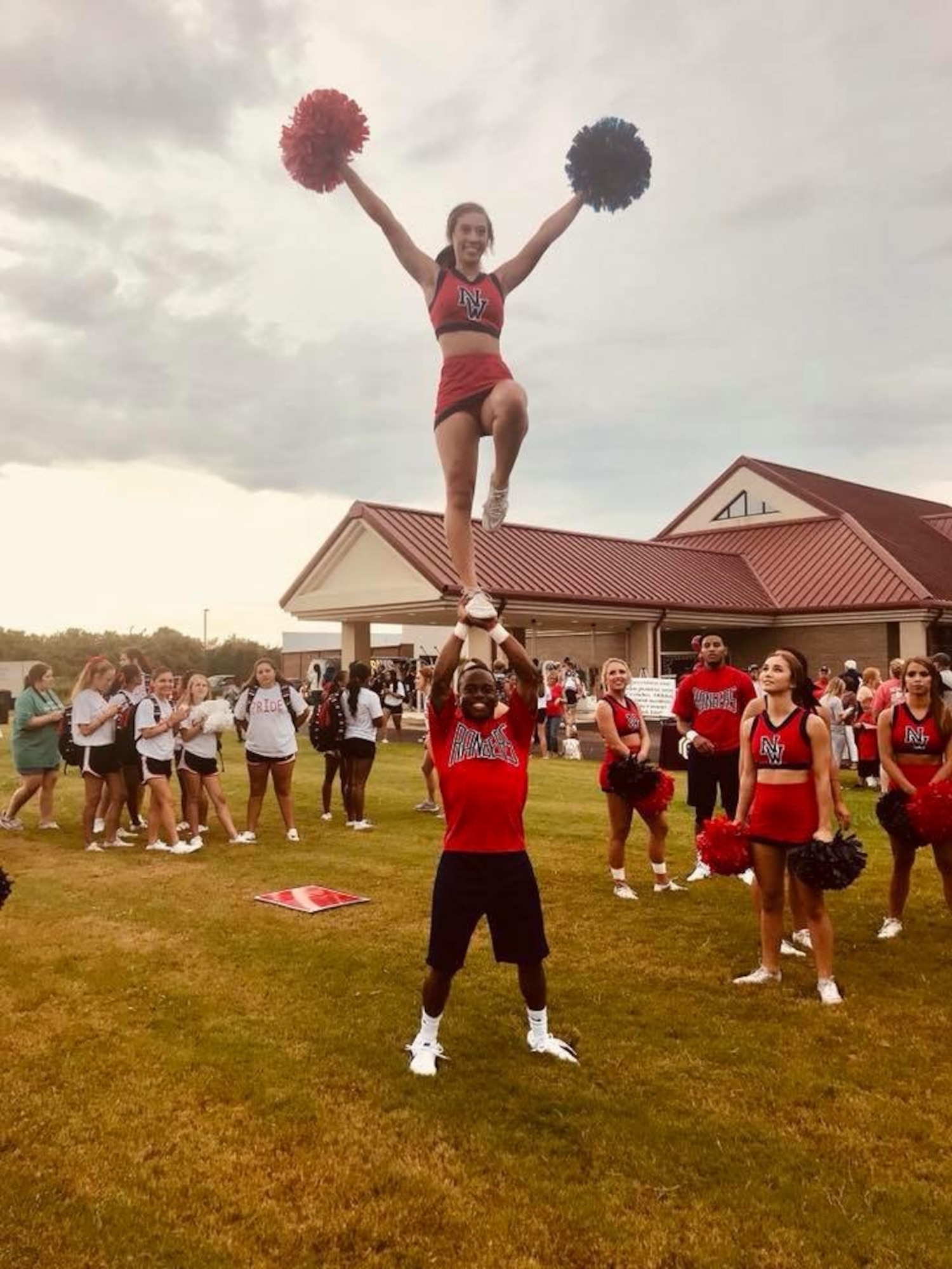 Satsha Burden lifts a fellow cheerleader during his time as a student at Northwest Mississippi Community College. Burden is a test engineer and test manager for the 716th Test Squadron Store Separation Group at Arnold Air Force Base, Tenn., headquarters of Arnold Engineering Development Complex. Burden was recently named the recipient of the 2026 Northwest Mississippi Community College Foundation Young Alumni Professional Achievement Award. He began his career at Arnold in 2022. (Courtesy photo)