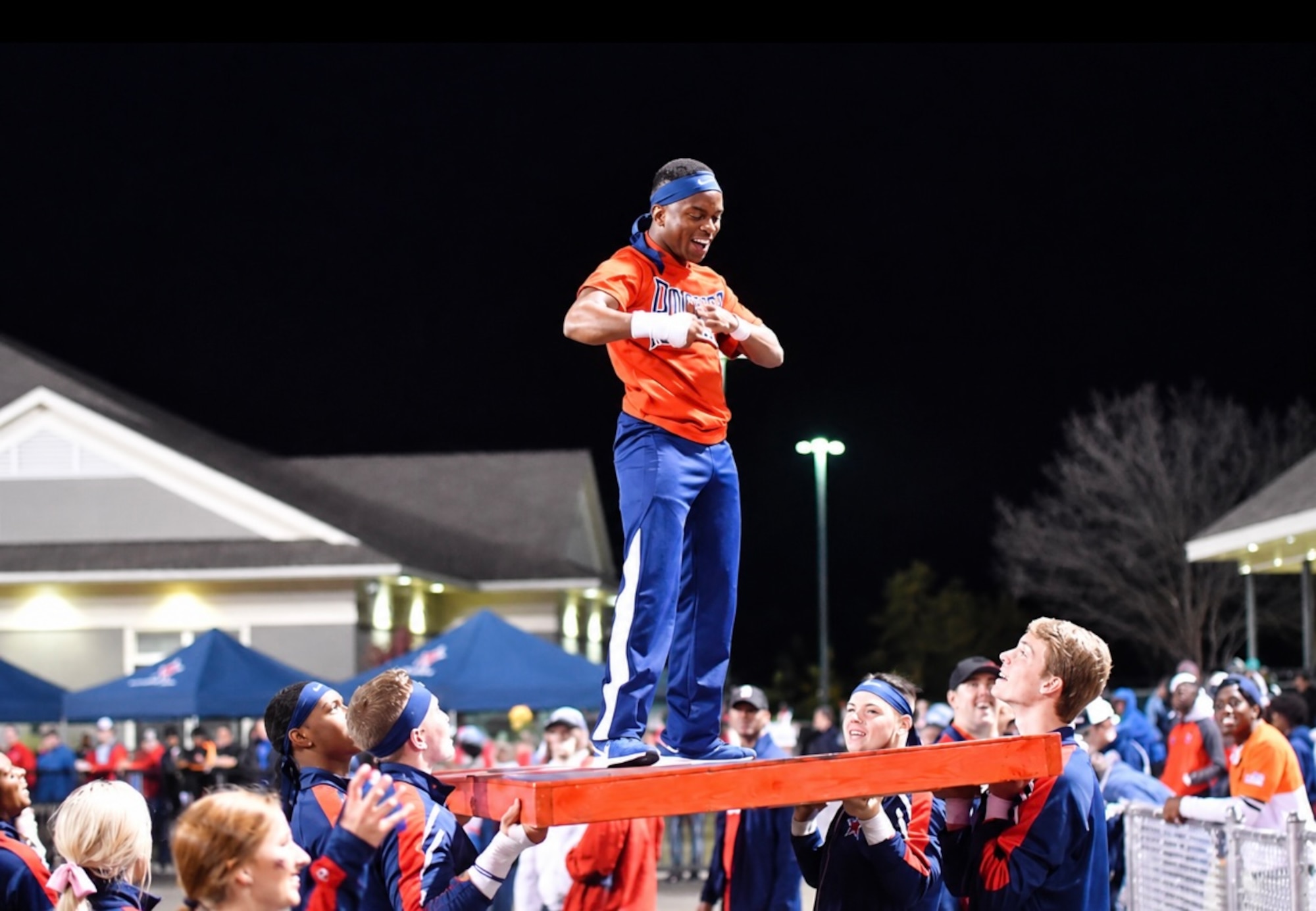 Satsha Burden, center, encourages fans to show their school spirit during his time as a student at Northwest Mississippi Community College. Burden was a member of the school’s cheerleading squad. He is now a test engineer and test manager for the 716th Test Squadron Store Separation Group at Arnold Air Force Base, Tenn., headquarters of Arnold Engineering Development Complex. Burden was recently named the recipient of the 2026 Northwest Mississippi Community College Foundation Young Alumni Professional Achievement Award. He began his career at Arnold in 2022. (Courtesy photo)