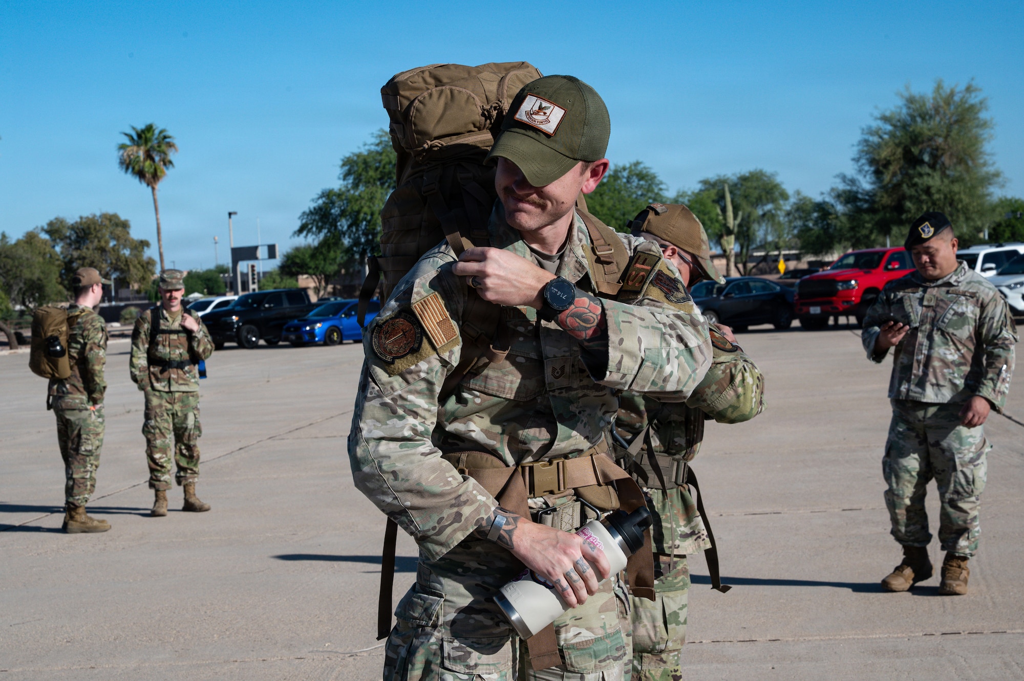 U.S. Air Force Tech Sgt. Logan Carpenter, 355th Security Forces Squadron flight sergeant adjusts rucksack strap before Police Week ruck at Davis-Monthan Air Force Base, Arizona, May 18, 2026. The Police Week ruck honors those who made the ultimate sacrifice and those who continue to serve with pride, purpose, and unwavering commitment to the mission and protection of our country. (U.S. Air Force photo by Airman 1st Class Rachael Wright)