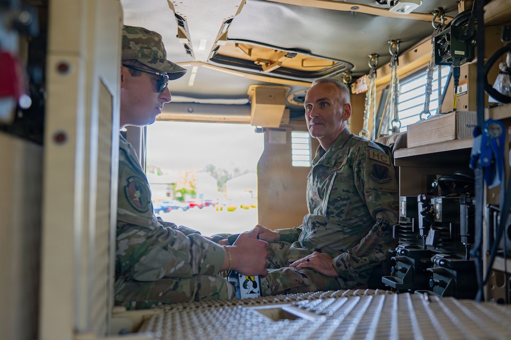 People sitting in an armored vehicle.