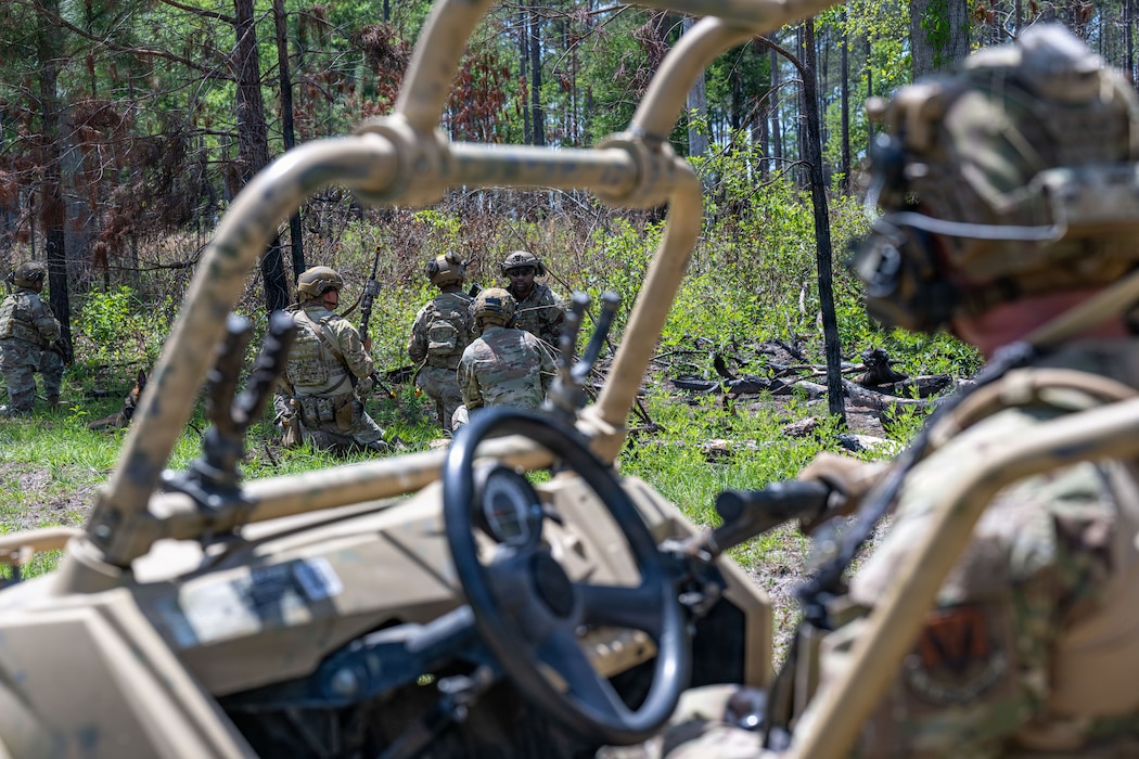 Military members in a huddle.