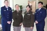 Group photo of service members wearing their service dress and smiling.