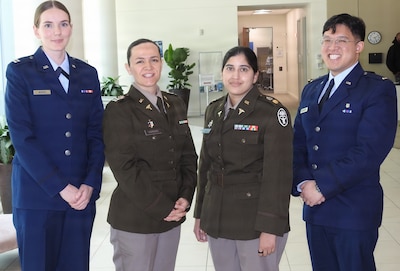 Group photo of service members wearing their service dress and smiling.