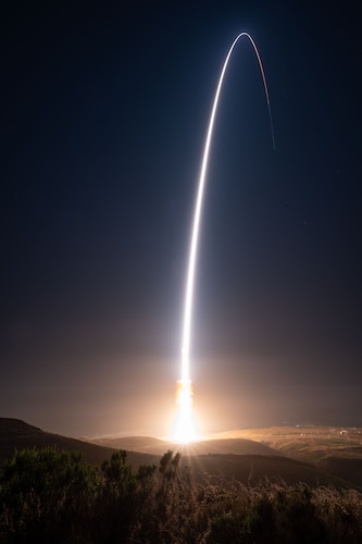 A rocket lights up the night sky.