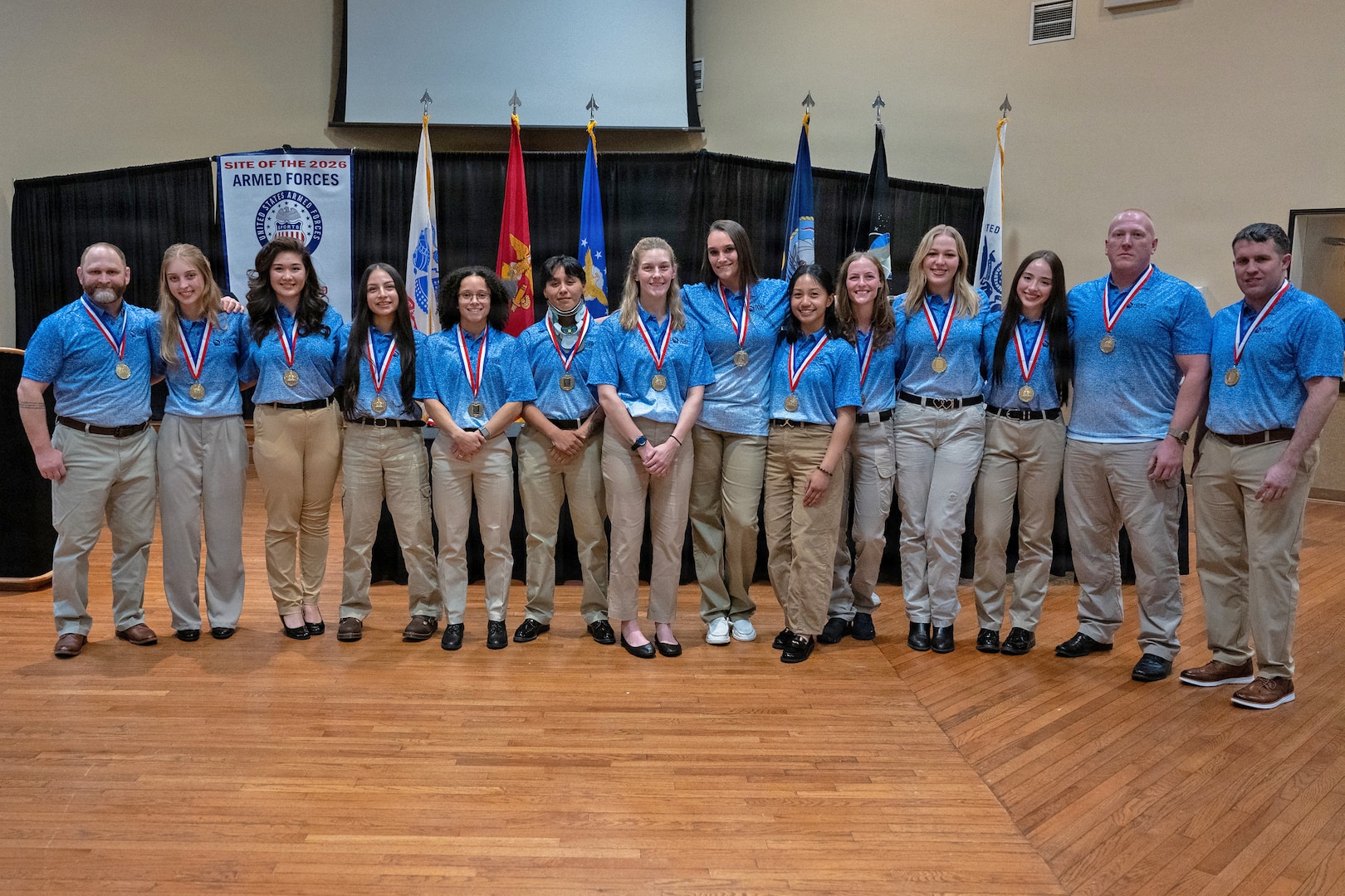 Lathwood (far right) and the Air Force Women's Wrestling Team pose for a photo after winning gold at the 2026 Armed Forces Wrestling Championship. The Armed Forces Sports Wrestling Championships bring together service members from the Army, Marine Corps, Navy (with Coast Guard athletes), and Air Force (with Space Force athletes) to compete at the national level.