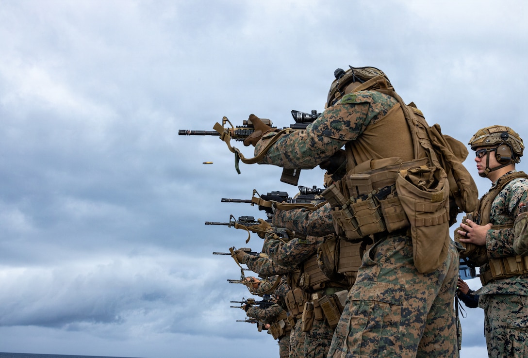 U.S. Marines with Haymaker Company, Battalion Landing Team 3rd Battalion, 1st Marine Regiment, 31st Marine Expeditionary Unit, fire an M4 carbine during a live-fire deck shoot aboard the forward-deployed amphibious assault ship USS New-Orleans (LPD 18) in the Philippine Sea, Feb. 11, 2026. Marines trained rifle skills through structured stages and live-fire exercises to improve individual marksmanship and overall unit effectiveness. The 31st MEU is a persistent, combat credible force operating aboard the ships of the Tripoli Amphibious Ready Group in the U.S. 7th Fleet area of operations, routinely interacting and operating with our allies and partners to contribute to deterrence, security, crisis response, and combat operations in the Indo-Pacific region. (U.S. Marine Corps photo by Cpl. Rebeka Falcon)