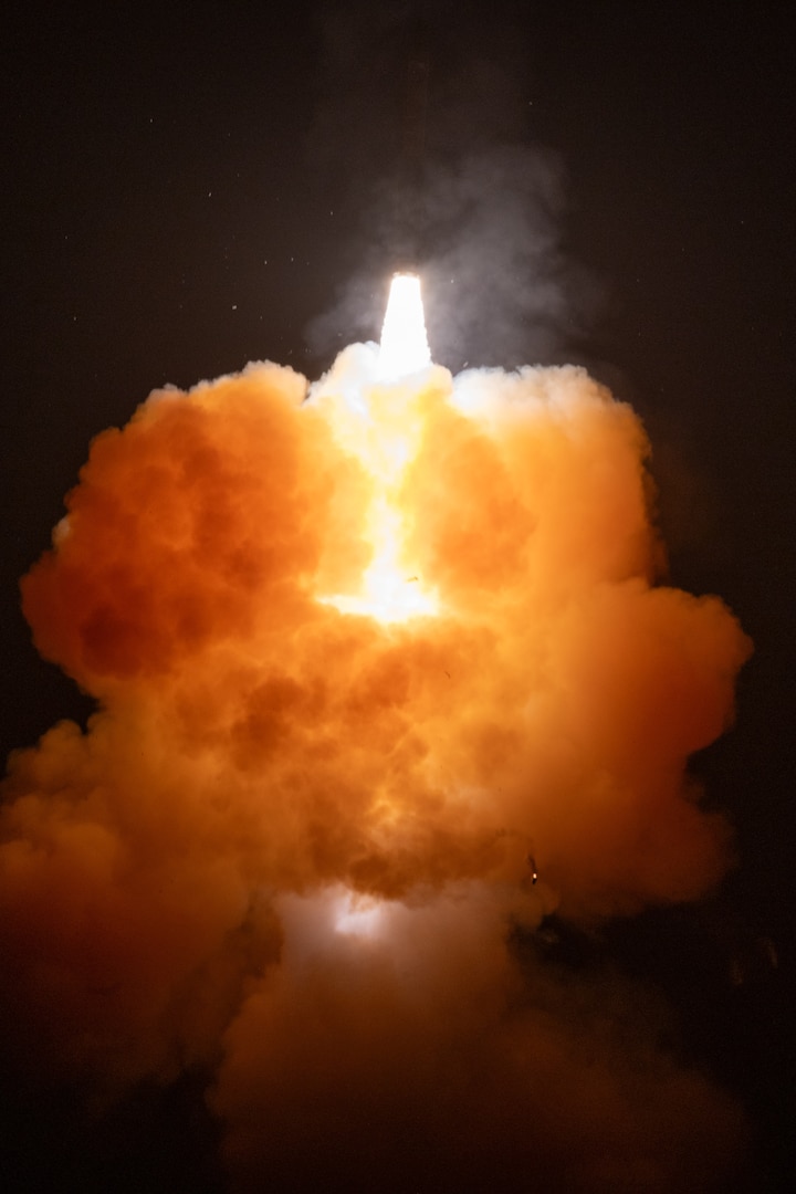 A rocket lights up the night sky.