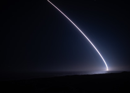A rocket lights up the night sky.