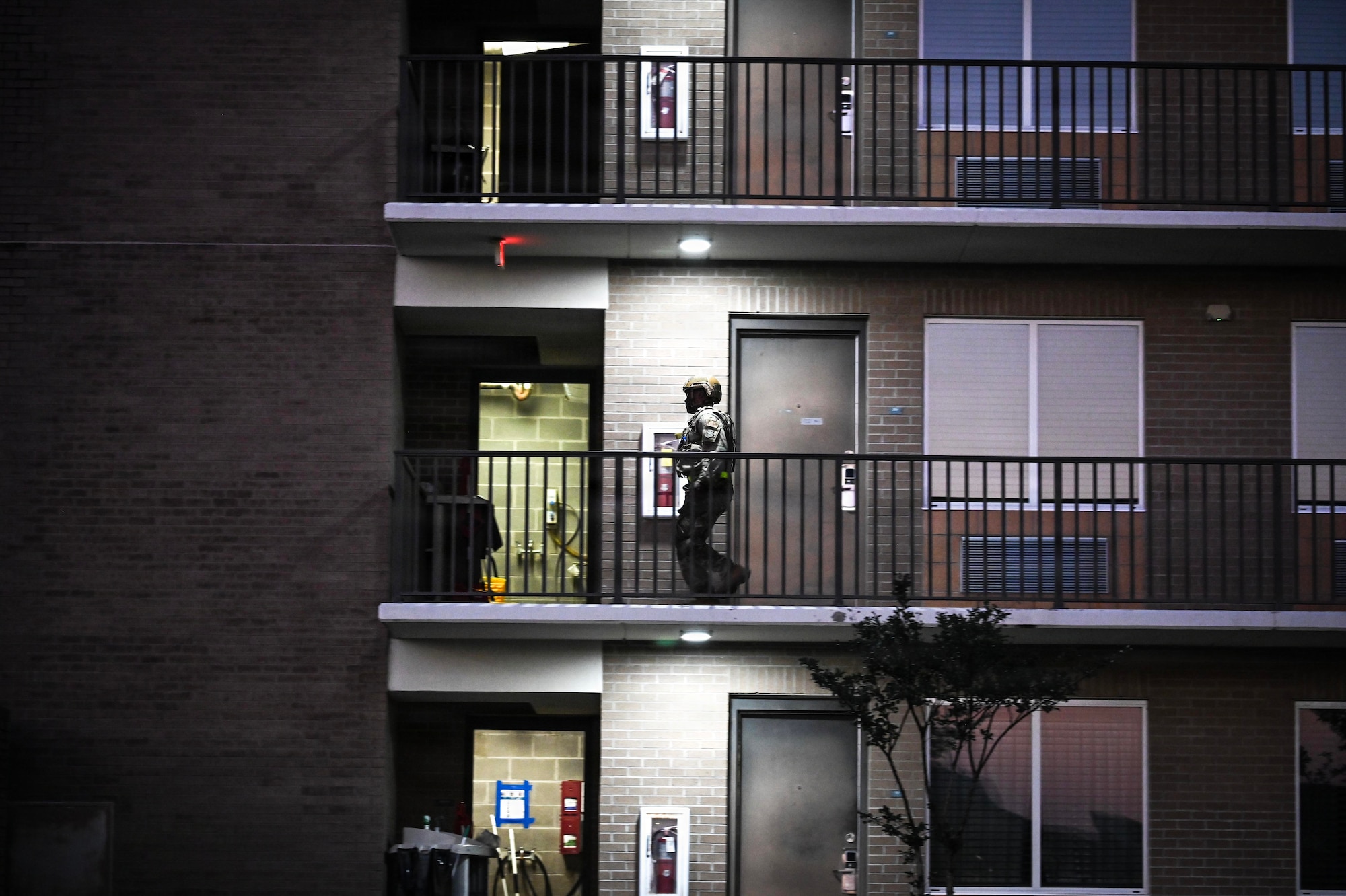A military members walks along a balcony.